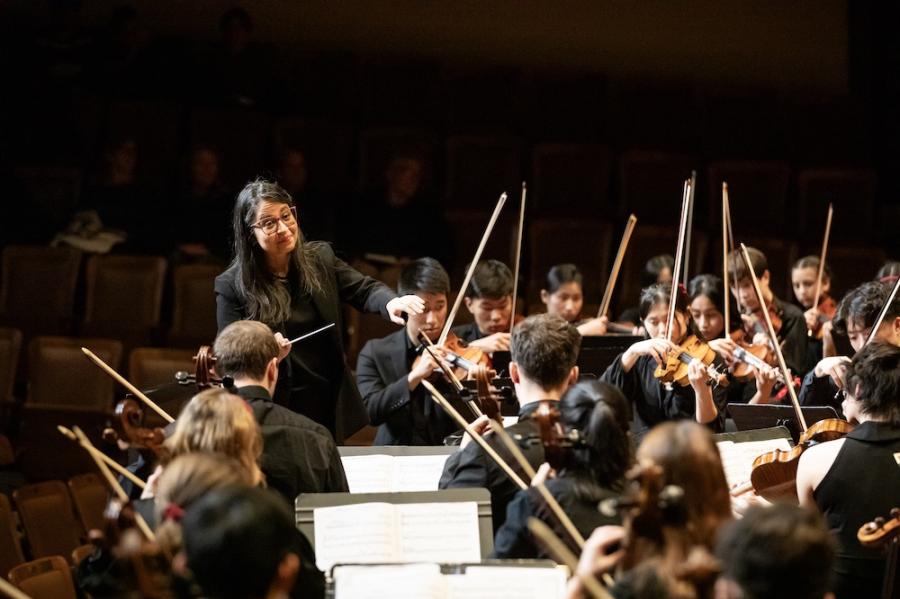 A conductor directs an orchestra