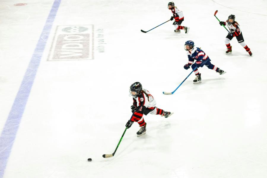 Four young ice hockey players, skating