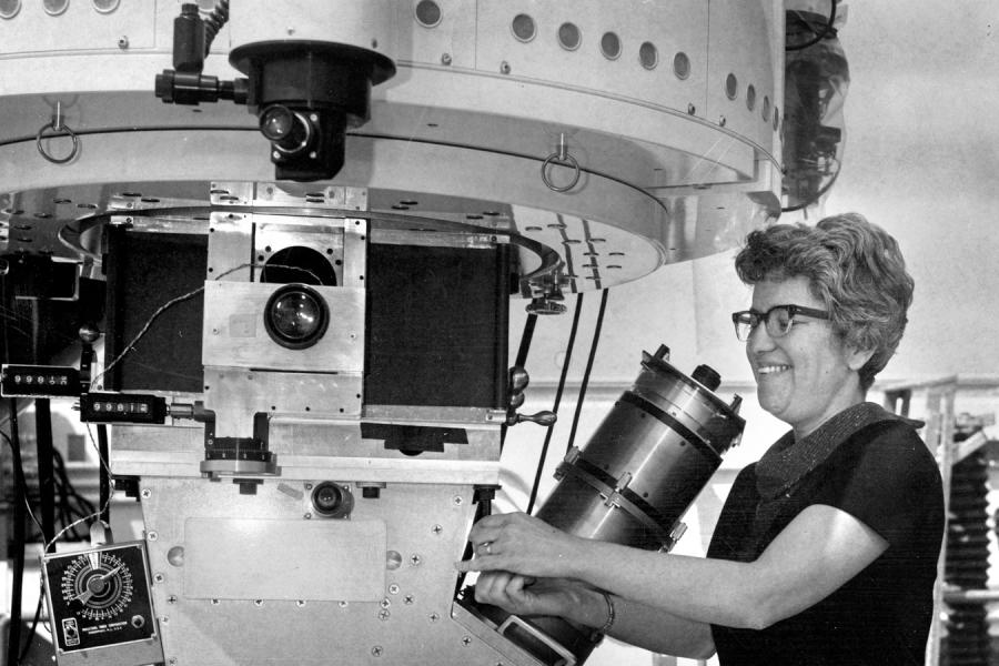 Person working on an enormous piece of equipment