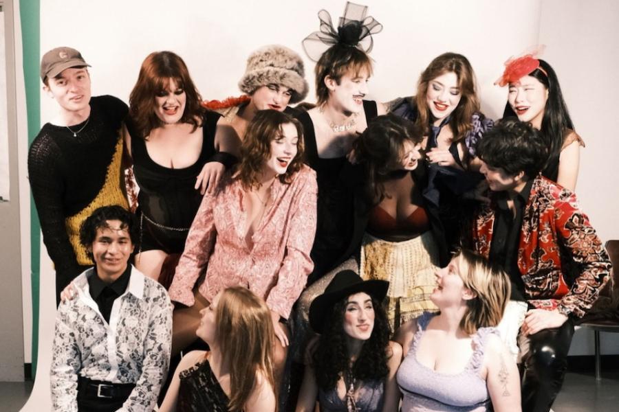 Several people dressed in costumes, clustered together