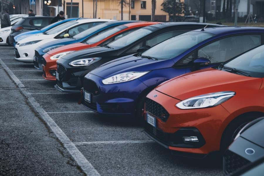 Row of cars for sale in a parking lot