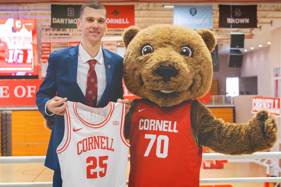 Person standing next to a bear mascot