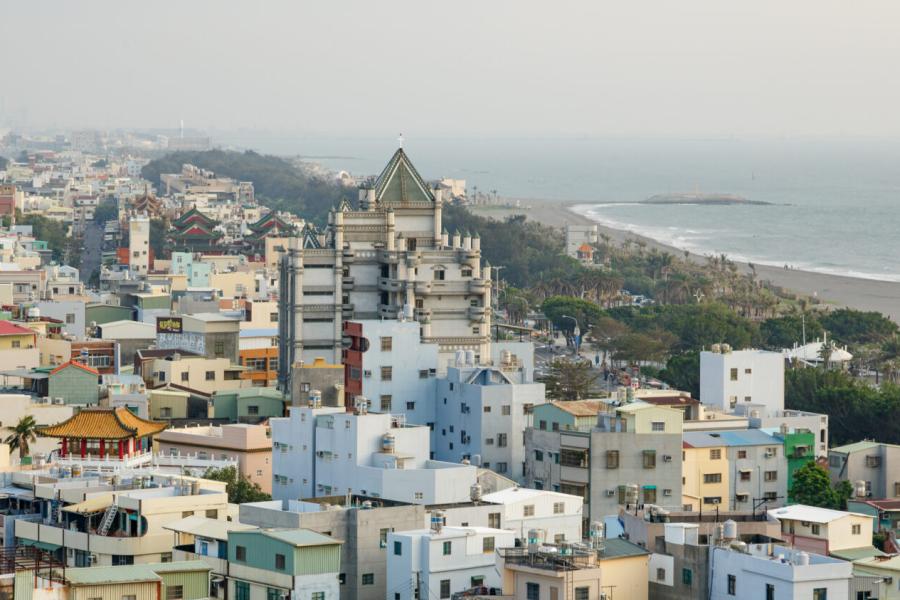 A city near a coastline; cloudy sky