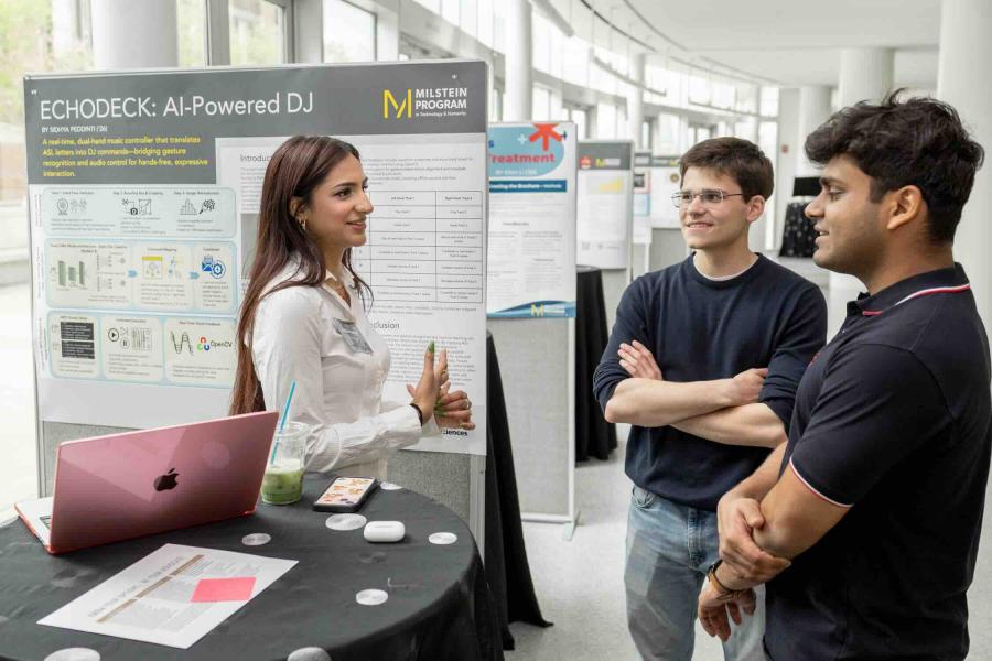 three people looking at a poster