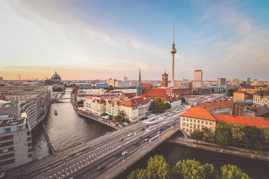 View of a city (Berlin) from above: river and red-roofed buildings