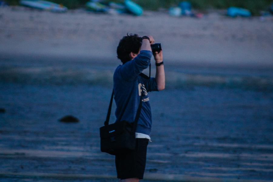 person taking a photo at dusk