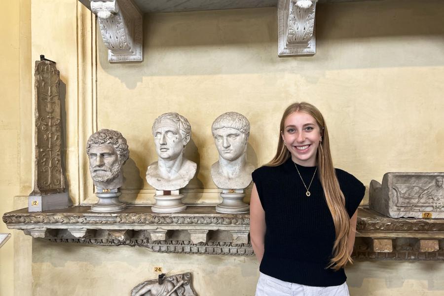 person standing near ancient busts