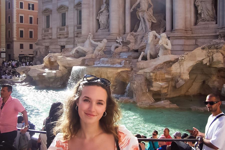 person standing outside ancient building