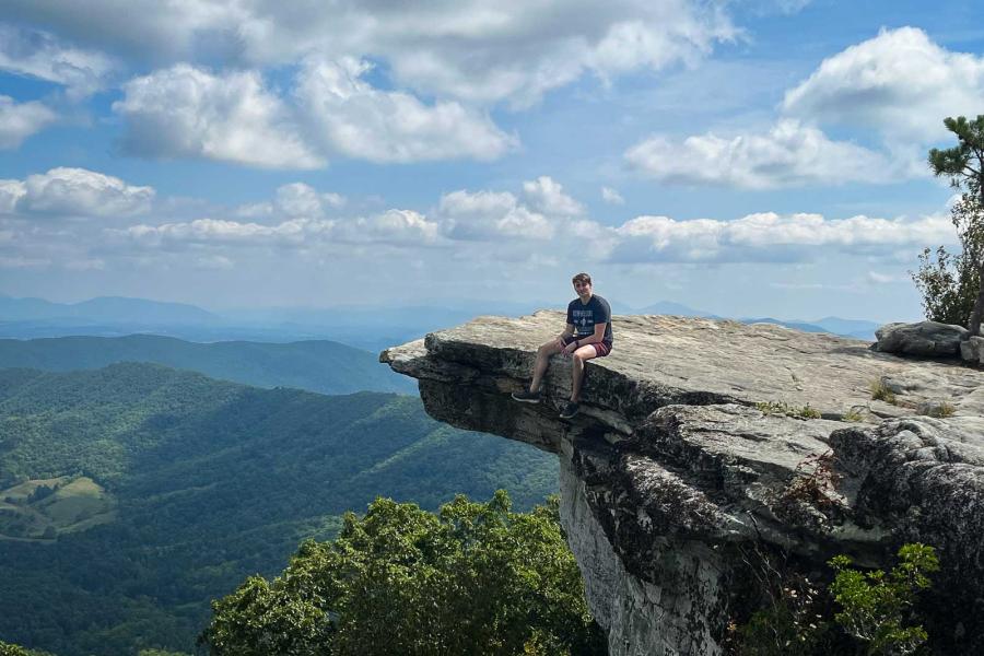 person on edge of mountain