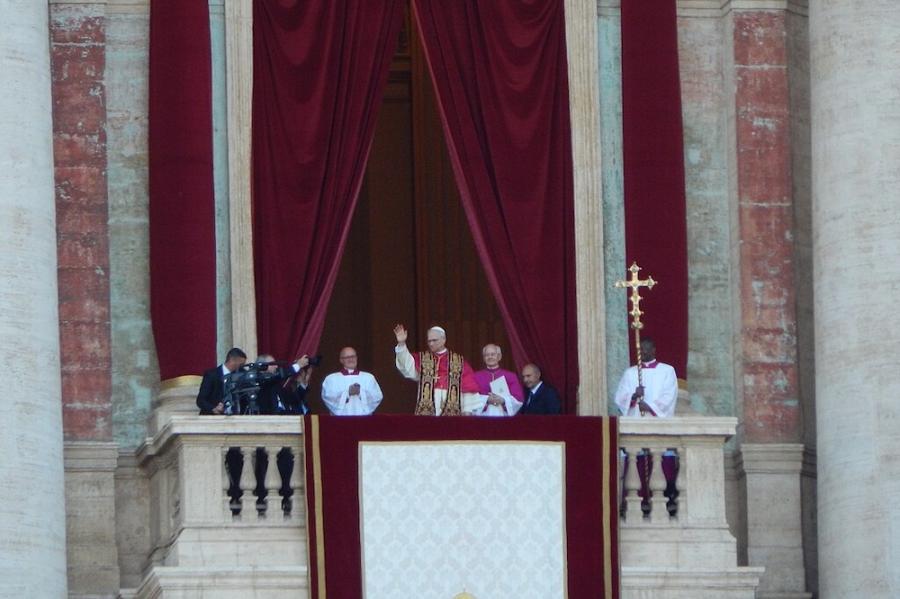 People in religious robes on a balcony