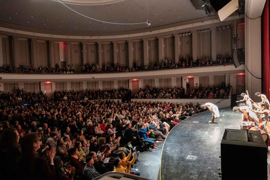 people on a stage taking a bow