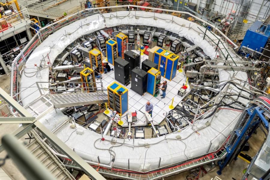 A huge ring with electronic wiring going into the center, along with a ladder-like stairs.