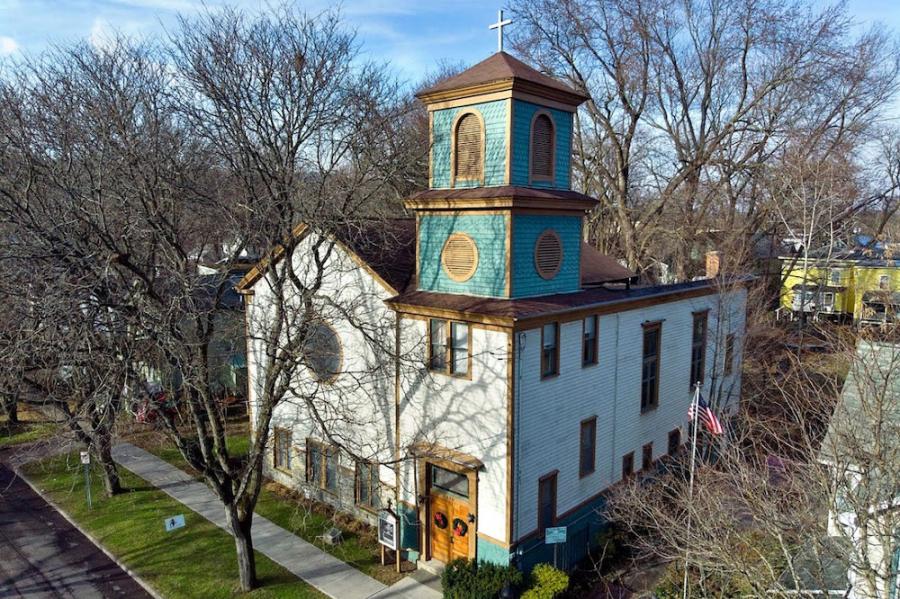 church building with a green-blue bell tower
