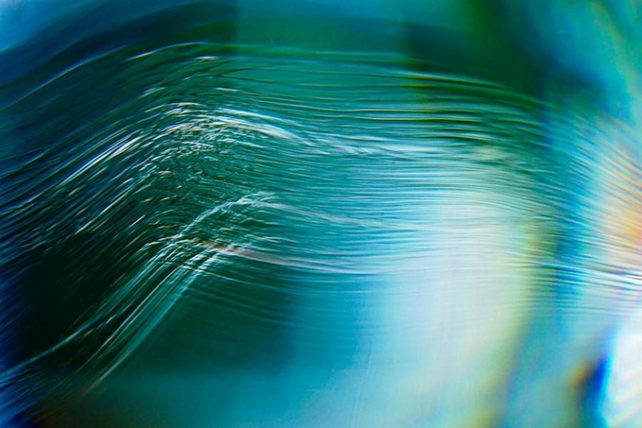 Abstract image in blue and green with lines running in parallel