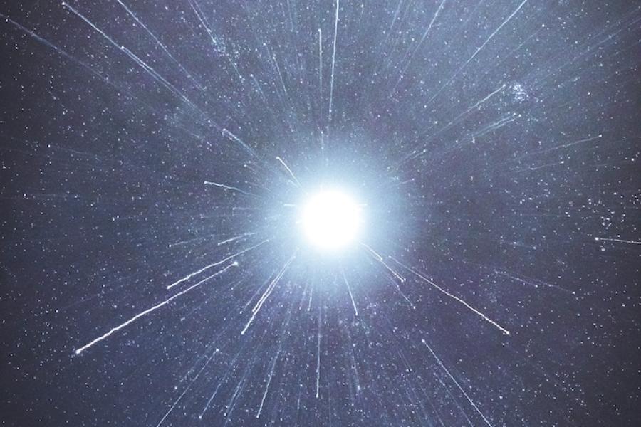 White spark of light against a blue-black background