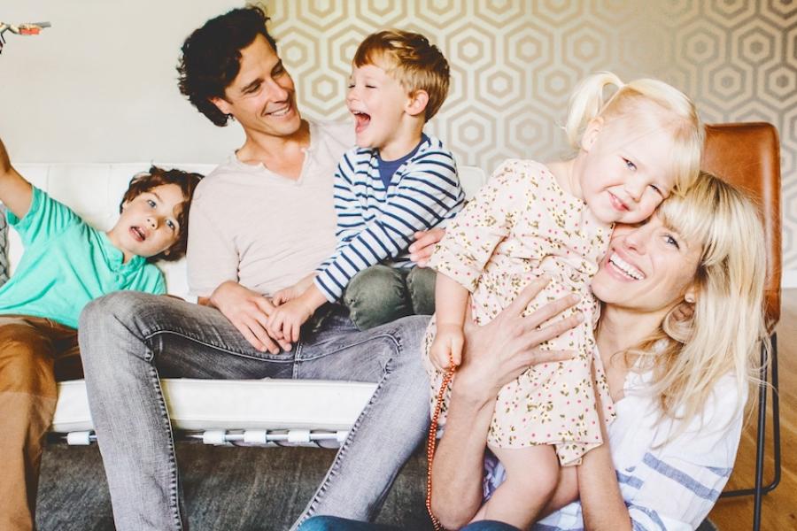 Family of five on and in front of a couch