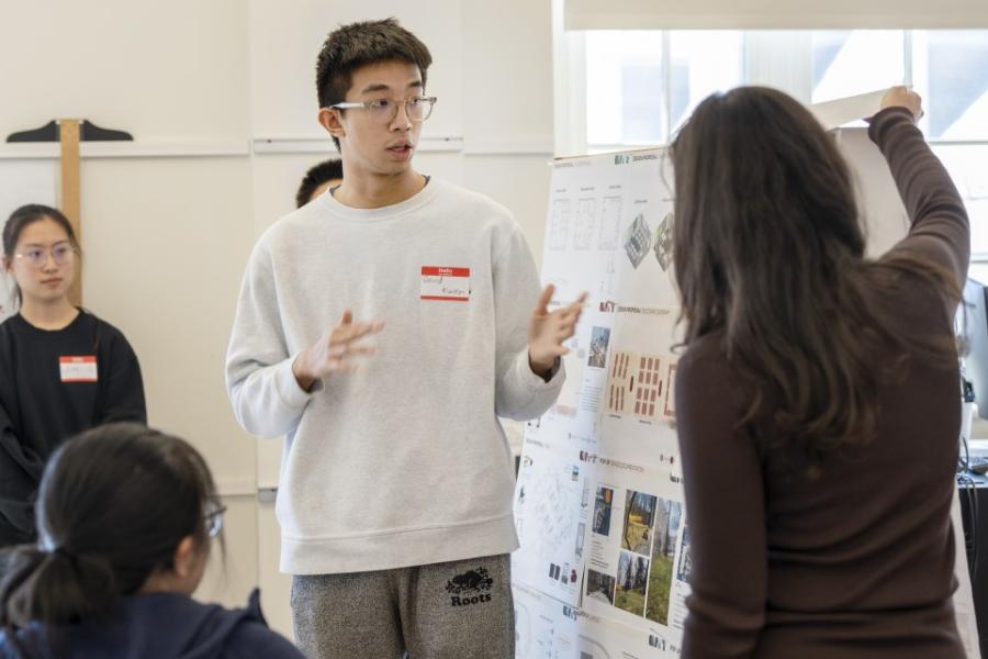 People giving a presentation with a poster