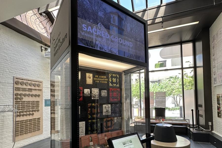 Tall display case in a museum room that's full of light