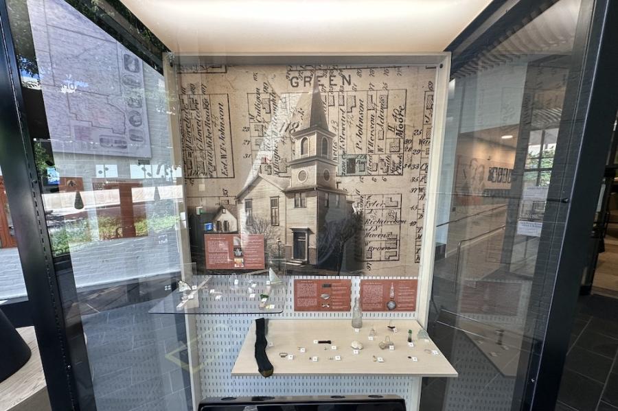 Museum display case showing a drawing of a church