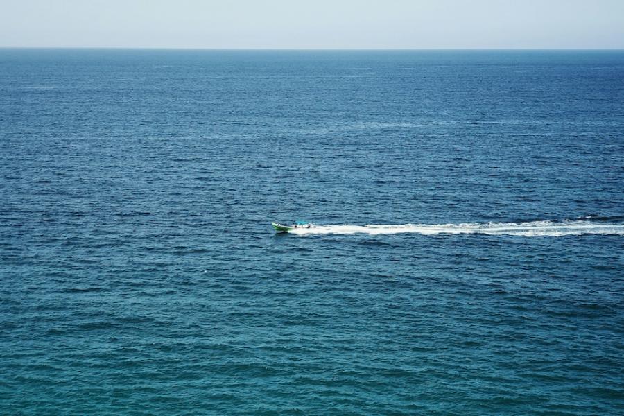 small boat traveling over open water