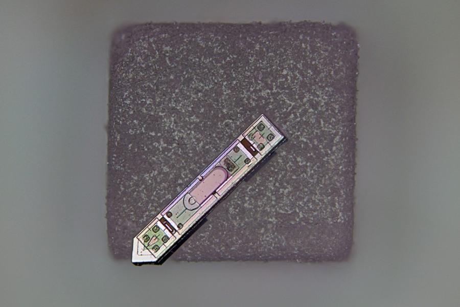 Grey square topped by a silver arrow-shaped object