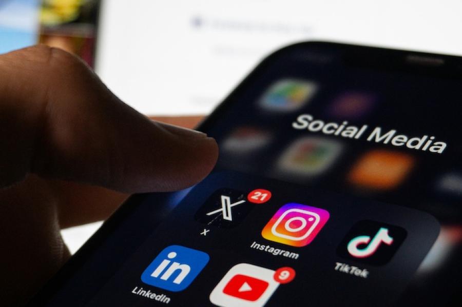 phone with dark mode screen and social media icons