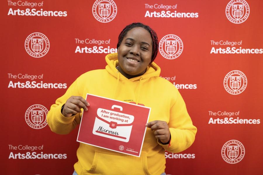 person holding sign saying they are working for Microsoft