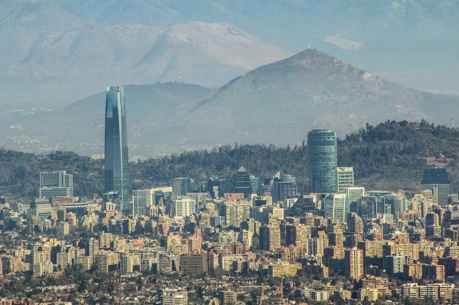 looking down on a large city set among mountains