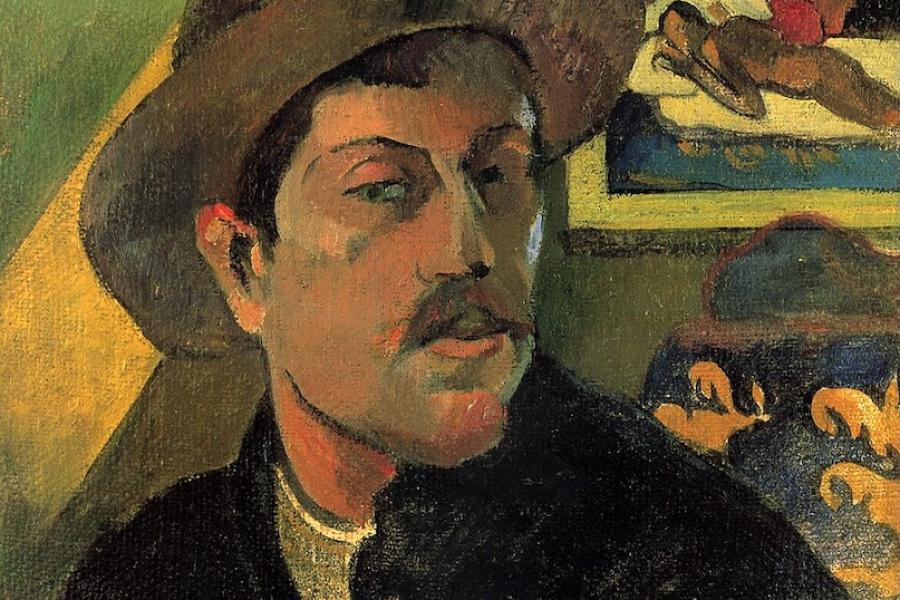 painting by Paul Gauguin showing the artist wearing a hat with a wall and some furniture behind him. On the wall is a framed painting of a person lying on a bed