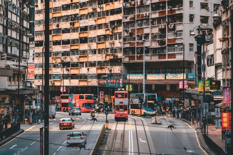 High rise apartment building fronting a city street with a trolley