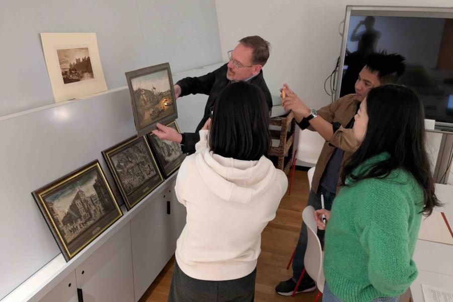 people standing around a portrait
