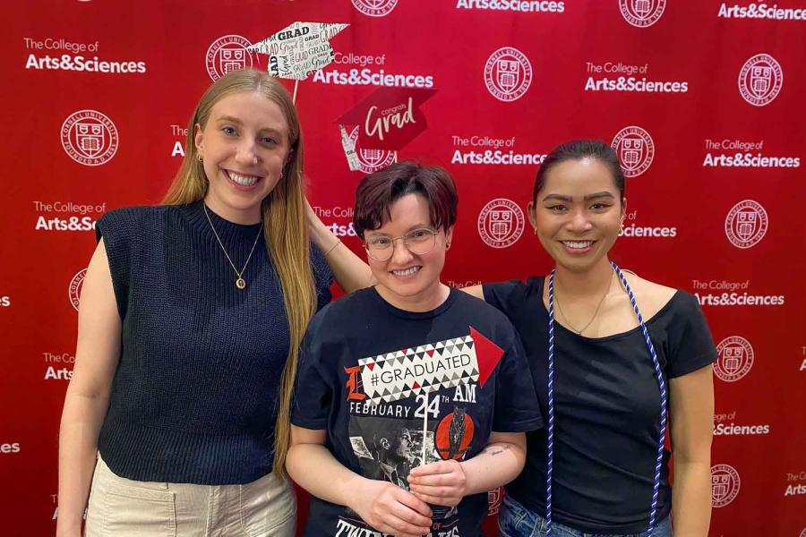 three people standing with signs