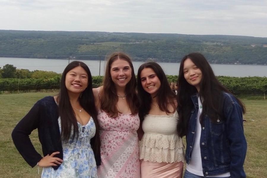 group of students with lake in background