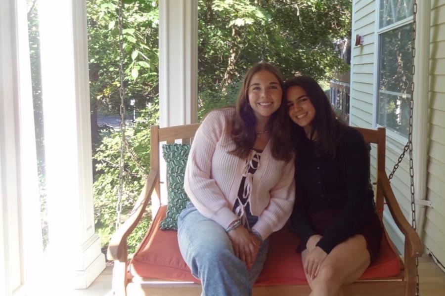 two people sitting in a swing