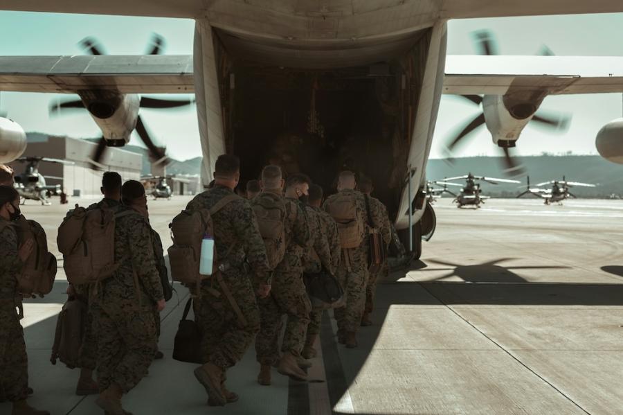 U.S. marines and sailors loading into an aircraft