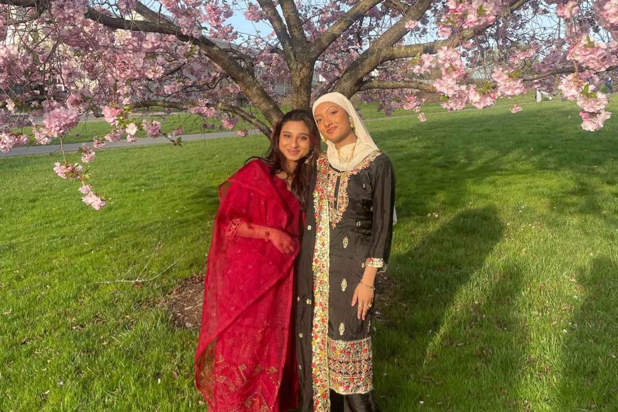 two people standing under a flowering tree