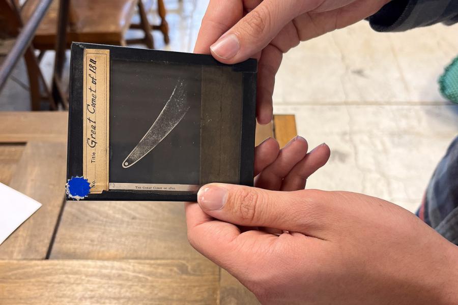 person holding a lantern slide