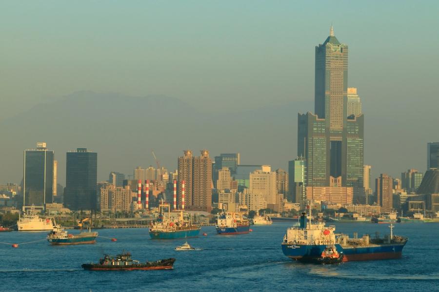 City skyline with a waterway in the foreground, filled with boats