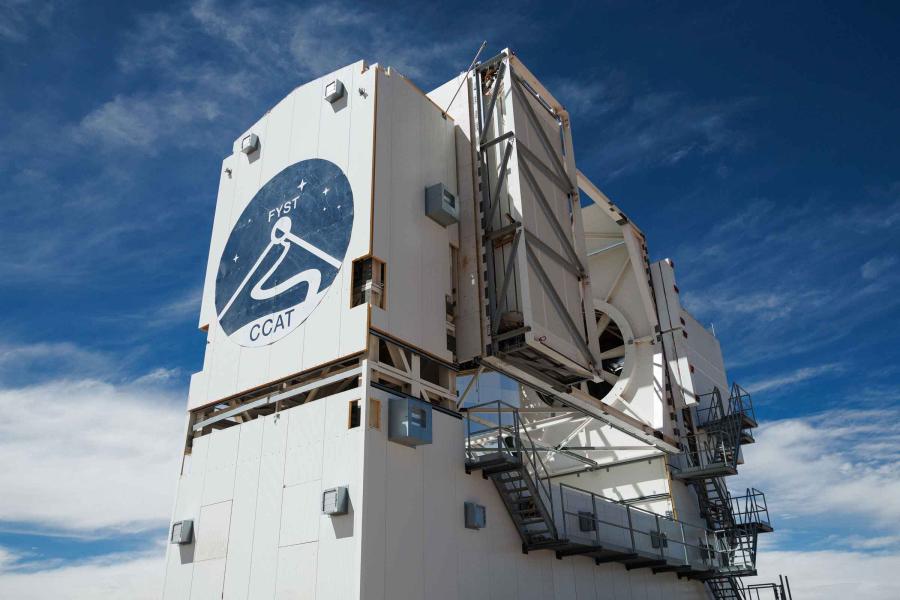 The telescope, a large white structure with the logo on the front, rises three stories in the air.
