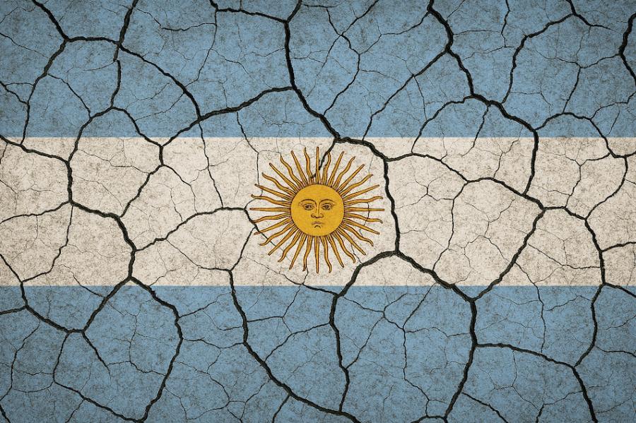 Image of the flag of Argentina (light blue bands on top and bottom with a white band in the middle and a stylized sun with a face) overlaid by cracks