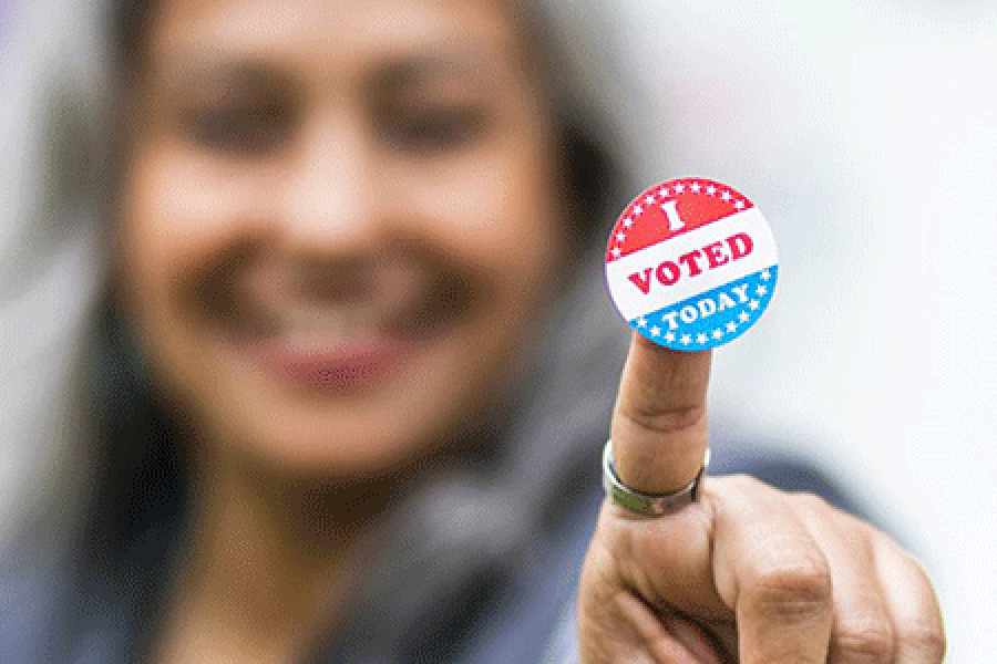  Voting sticker help up by a smiling person
