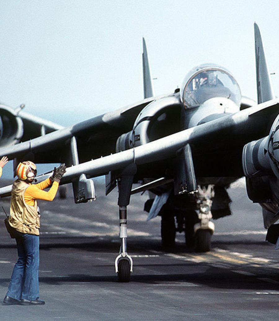  Person on tarmac next to fighter jets