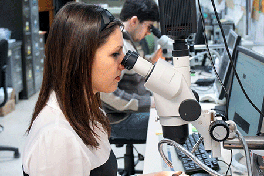 Person looking into a microscope