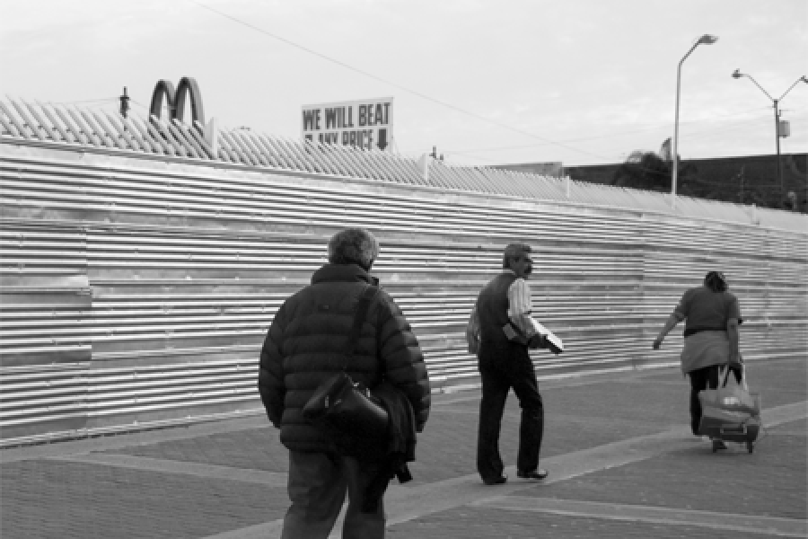  People walking along fence