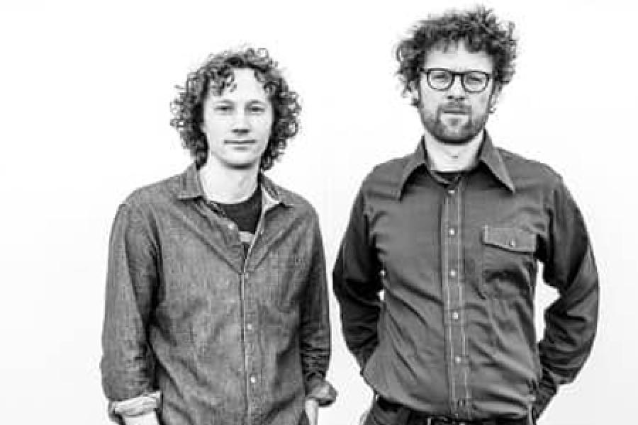  Radio producers Chris Hoff and Sam Harnett standing together in black and white