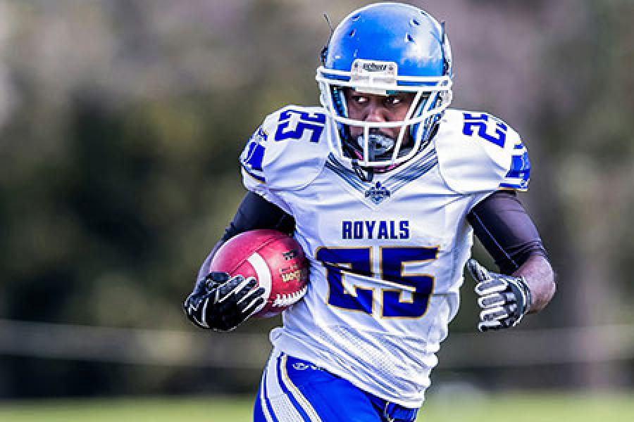  Black football player running with the ball