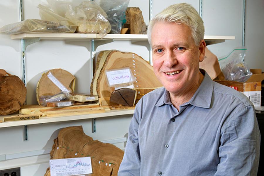 Person with shelves of artifacts