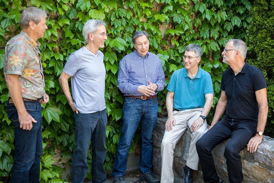 From left: Professors William Schulze, Thomas Gilovich, J. Edward Russo, Ted O’Donoghue and Robert Frank, standing in front of some leafy ivy