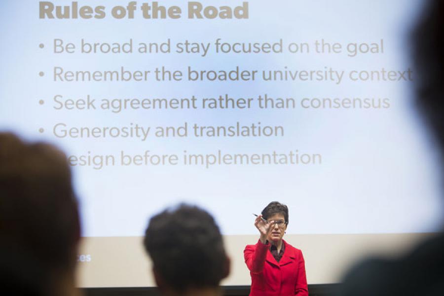 Gretchen Ritter backed by PowerPoint slide about the &quot;Rules of the Road&quot;