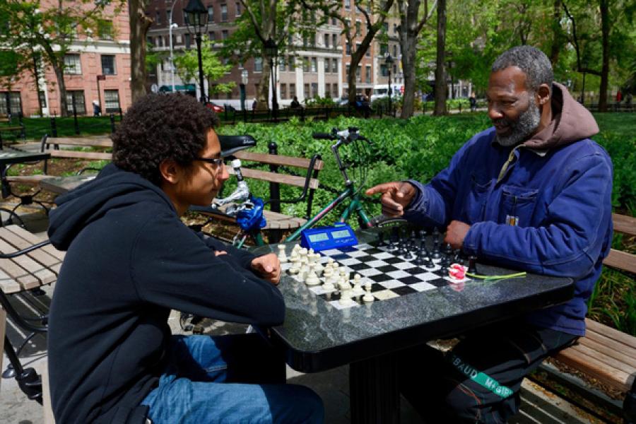 Joe, a chess master who formerly “hustled” chess games in Washington Square Park, now teaches people to play chess.
